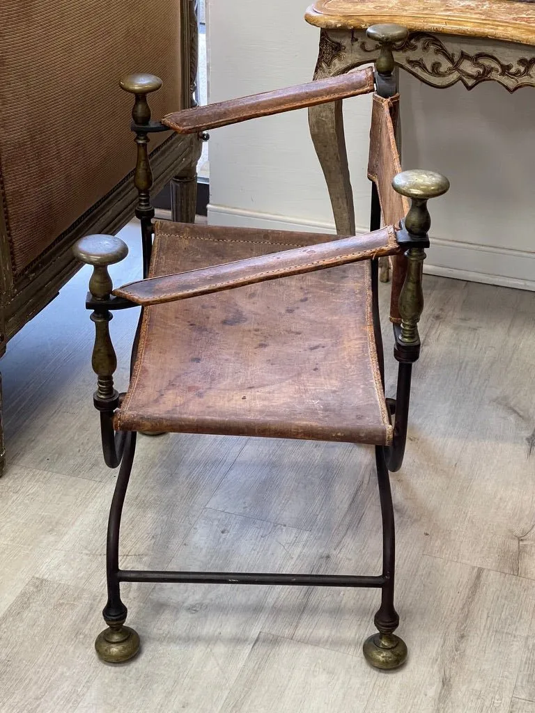 19th Century Italian iron, bronze, and leather Savonarola chair.